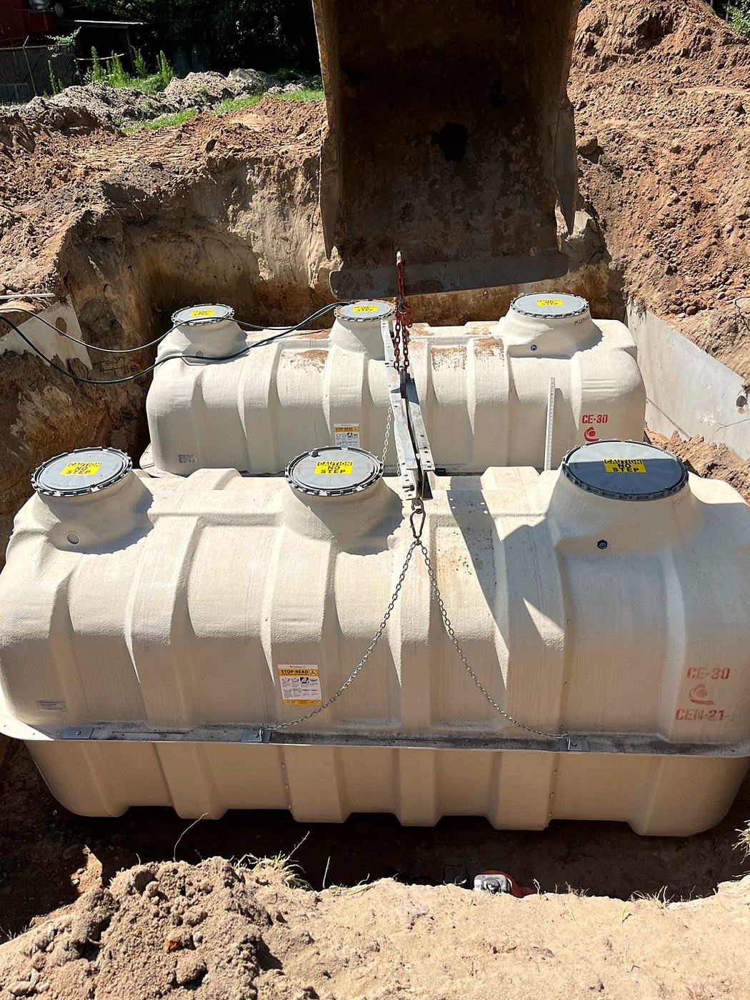 Fuji Clean CE-30 treatment units being lowered into an excavated pit